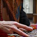 Moroccan artisan weaving a rug
