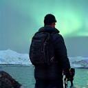Mark, a photographer, capturing the Northern Lights over a glacial lagoon in Iceland
